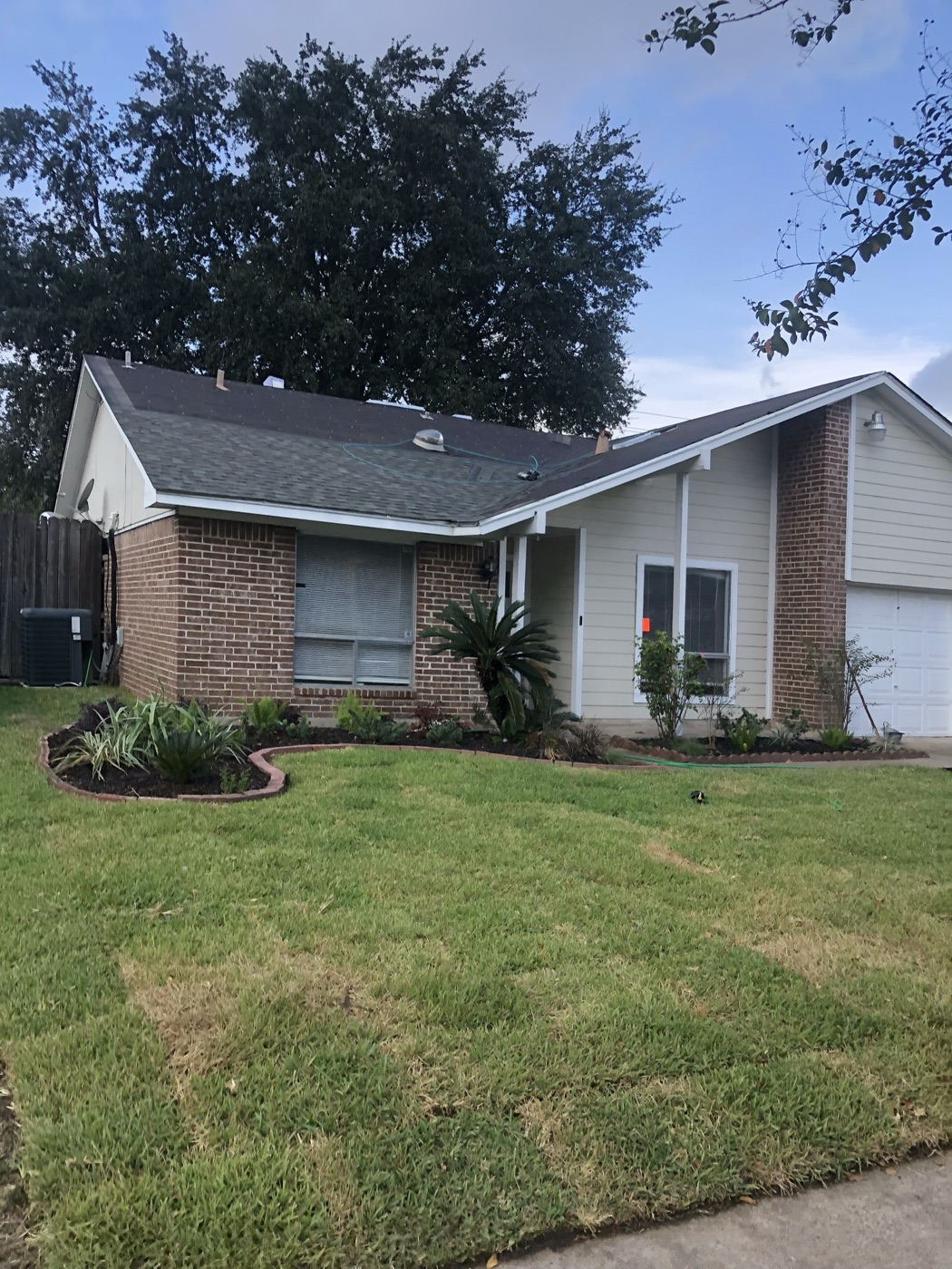 Home exterior with a newly installed roof — AttarCo Homes roof replacement in Houston, TX