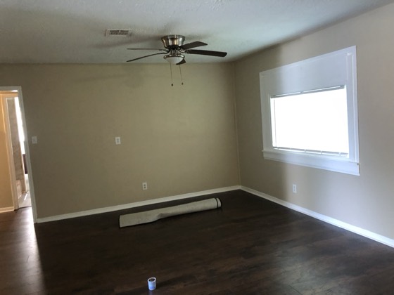 Bright finished living room with fresh paint and wood floors — AttarCo Homes roofing & remodeling project, Houston TX