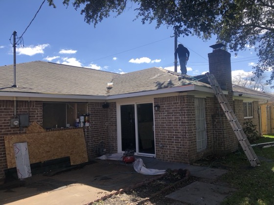 Completed reroof on brick home, blue sky — AttarCo Homes roofing & remodeling project, Houston TX