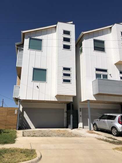 Contemporary white townhome exterior detail — AttarCo Homes roofing & remodeling project, Houston TX