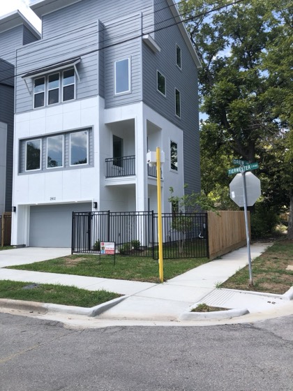 Corner-lot three-story new build with balcony — AttarCo Homes roofing & remodeling project, Houston TX