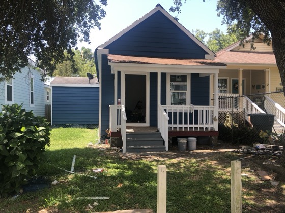 Cottage after navy-blue exterior repaint — AttarCo Homes roofing & remodeling project, Houston TX