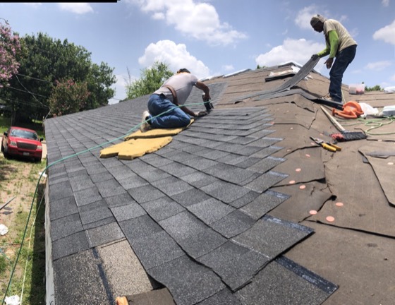 Crew hand-nailing architectural shingles — AttarCo Homes roofing & remodeling project, Houston TX