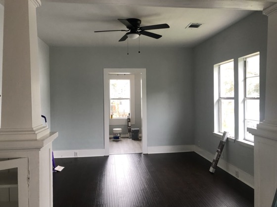 Finished living room with dark floors and gray walls — AttarCo Homes roofing & remodeling project, Houston TX