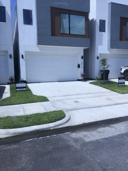 Finished modern townhome exterior and driveway — AttarCo Homes roofing & remodeling project, Houston TX