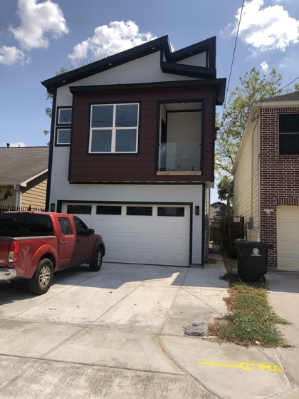 Finished two-story home with dark siding — AttarCo Homes roofing & remodeling project, Houston TX