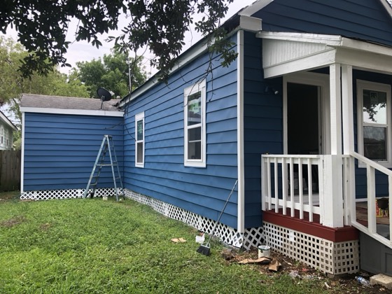 Fresh blue siding and porch with new lattice skirting — AttarCo Homes roofing & remodeling project, Houston TX