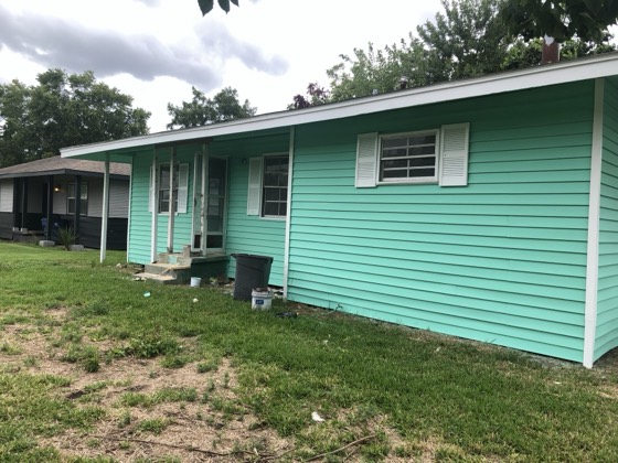 Freshly painted mint green home exterior — AttarCo Homes roofing & remodeling project, Houston TX