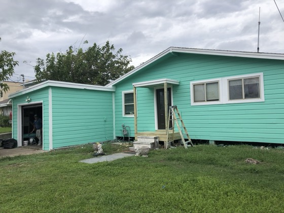 Freshly painted teal home with matching garage — AttarCo Homes roofing & remodeling project, Houston TX