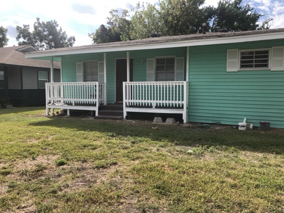 Freshly painted teal home with white porch — AttarCo Homes roofing & remodeling project, Houston TX