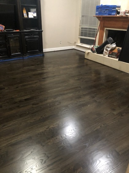 Refinished dark-stained hardwood floors — AttarCo Homes roofing & remodeling project, Houston TX