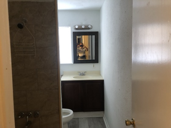 Remodeled bathroom with tiled shower and new vanity — AttarCo Homes roofing & remodeling project, Houston TX