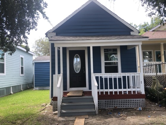 Renovated navy cottage with fresh paint and porch — AttarCo Homes roofing & remodeling project, Houston TX