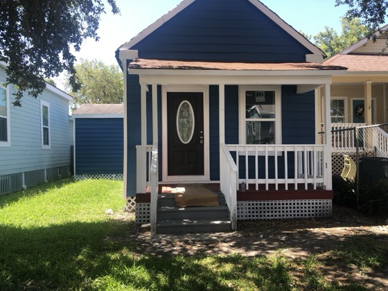 Renovated navy cottage with restored front porch — AttarCo Homes roofing & remodeling project, Houston TX