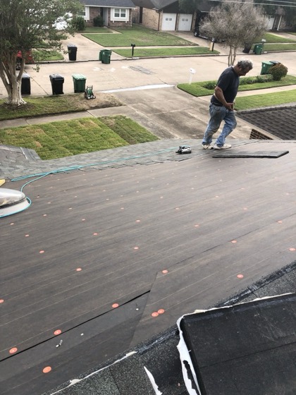 Roofer installing new shingles on the deck — AttarCo Homes roofing & remodeling project, Houston TX