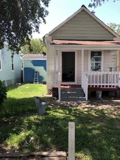 White cottage exterior before repaint — AttarCo Homes roofing & remodeling project, Houston TX